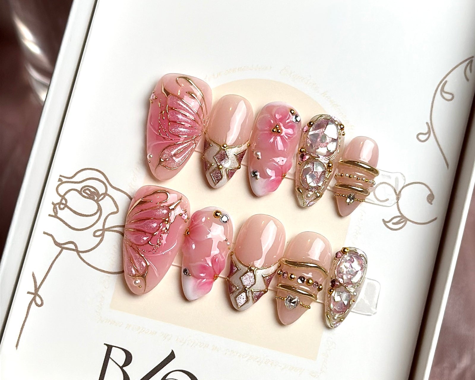 Venus Has Wings hand-painted press-on nails by Bloom Nails in their box