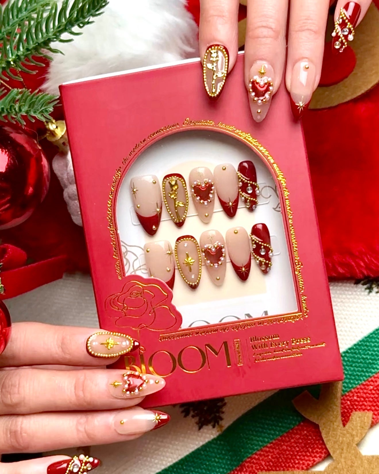 Golden Amour holiday press-on nails by Bloom Nails in a red gift box with holiday decor