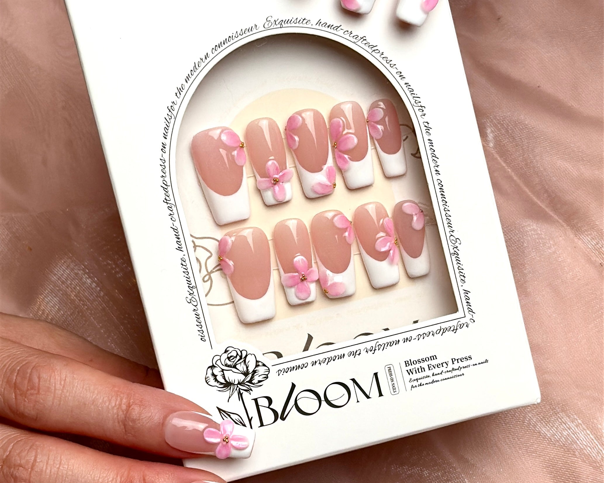 She Wore Flowers handmade press-on nails by Bloom Nails held in their reusable storage box