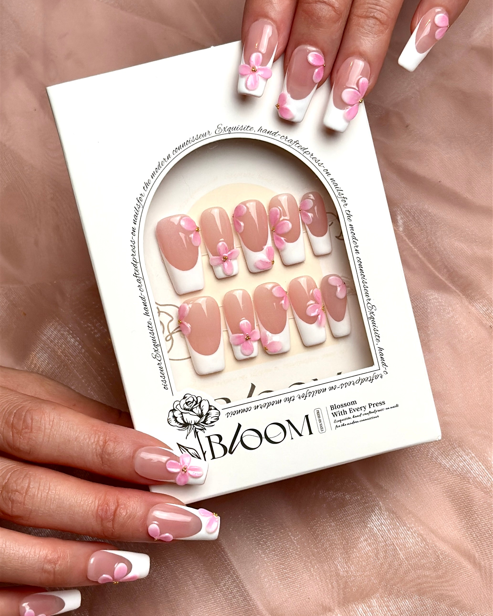 She Wore Flowers handmade press-on nails by Bloom Nails held in their reusable storage box