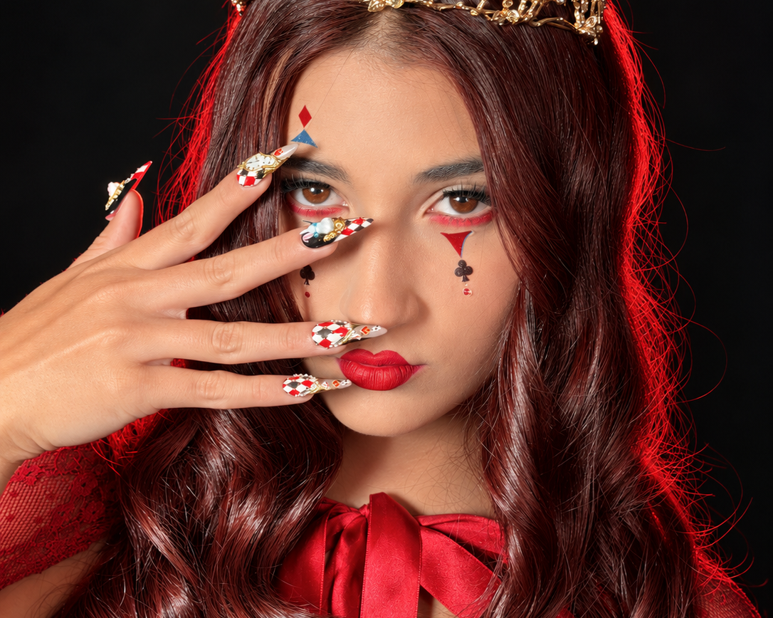 Model in a gold crown and red cape wearing Down the Rabbit Hole press-on nails from Bloom Midnight Cinema