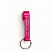 Hot pink Bloom can opener with white engraving and silver keyring