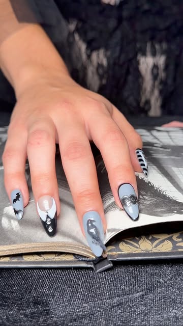 Instagram Reel: grey and black hand-painted Bloom nails over an open book