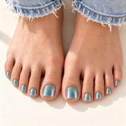 Bloom Blue Reverie press-on toenails (frosty blue cat-eye) worn with cuffed jeans