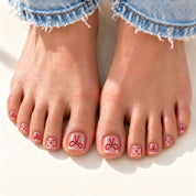 Bloom Tied in Rouge press-on toenails (red bows and dots on sheer pink) worn with cuffed jeans